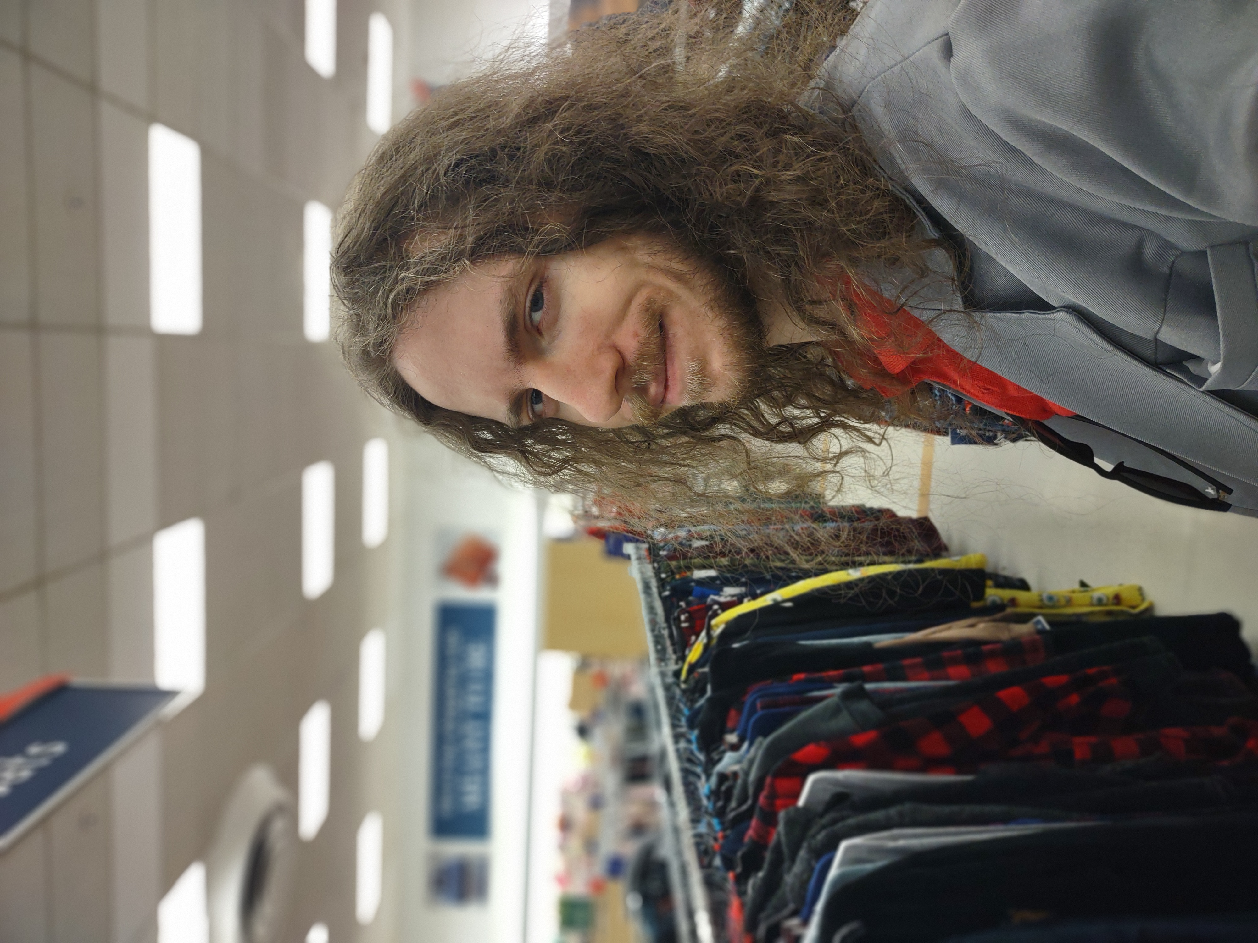 Brad standing around a Marshalls with a smug smile